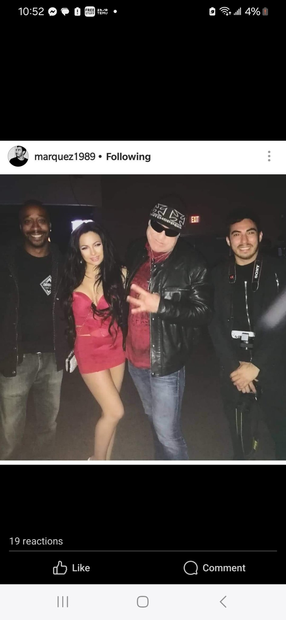 Jennifer Jorgensen Ahmed in a pink strapless dress posing with friends at a nightclub
