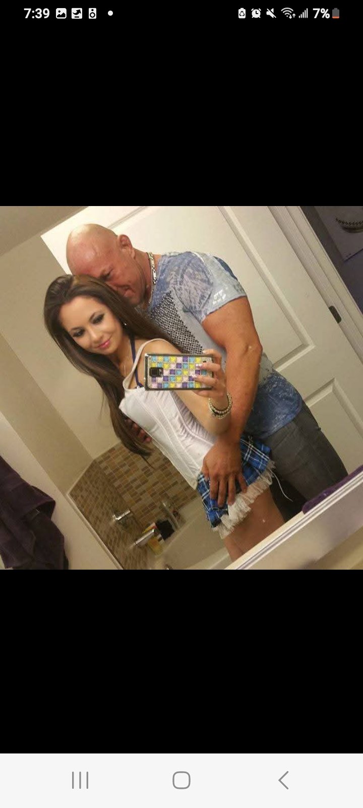 Jennifer Jorgensen Ahmed taking a bathroom mirror selfie with a companion