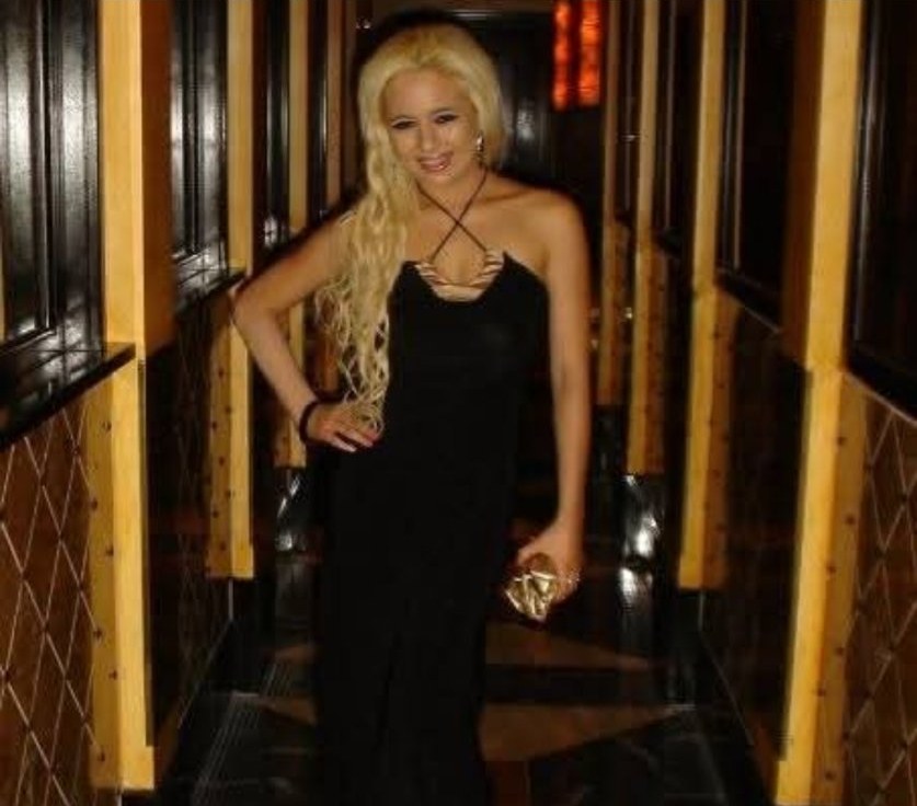 Jennifer Jorgensen Ahmed blonde in a black evening gown in a hallway, October 2014