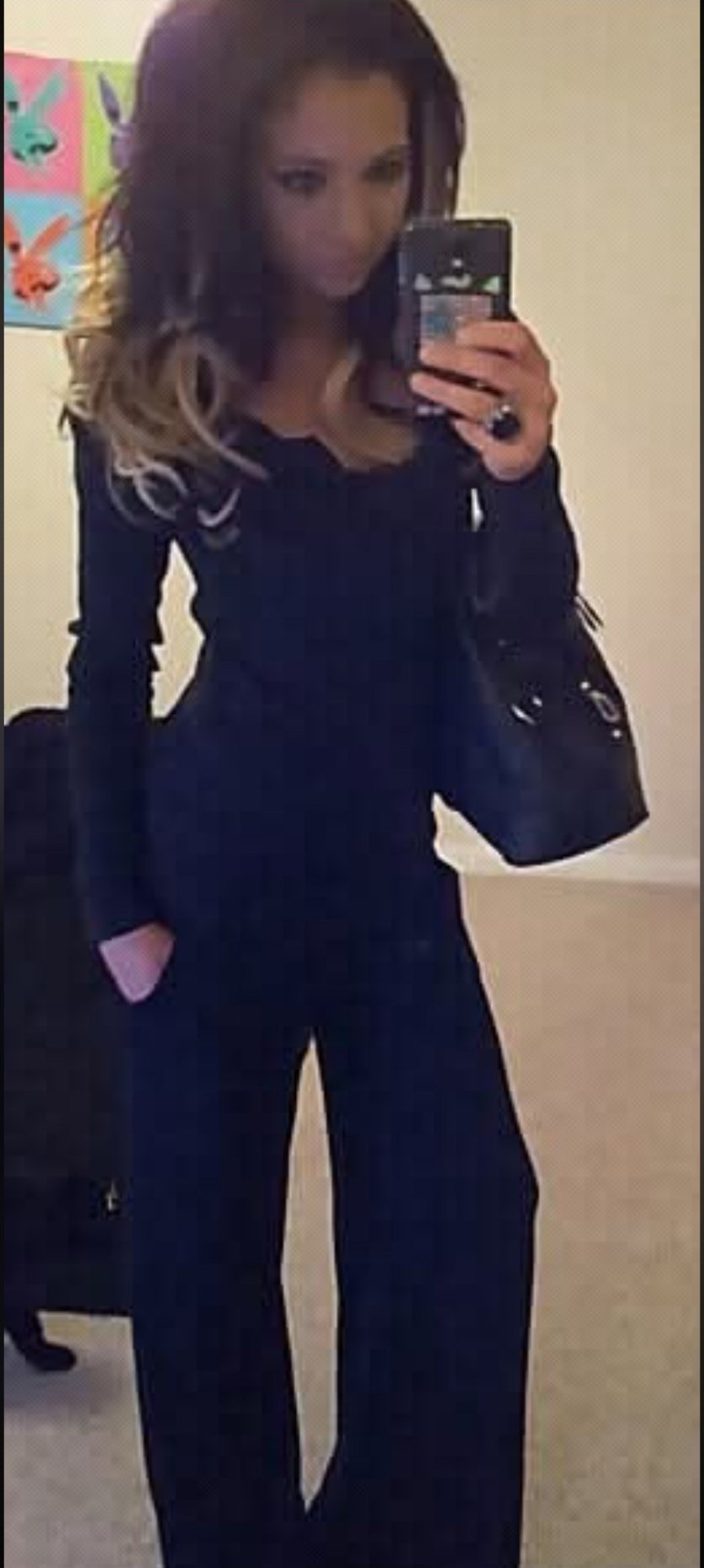 Jennifer Jorgensen Ahmed in a black outfit taking a mirror selfie
