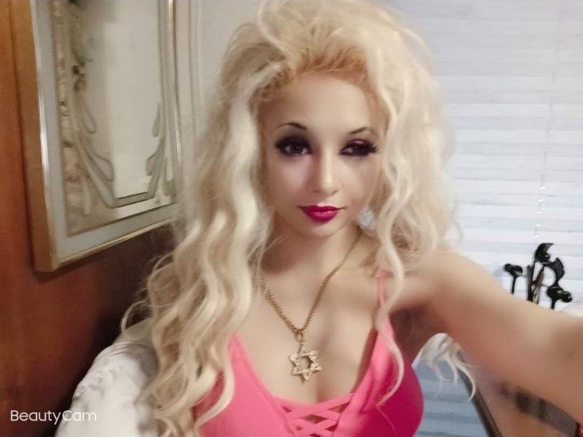 Jennifer Jorgensen Ahmed, blonde in a pink top, selfie